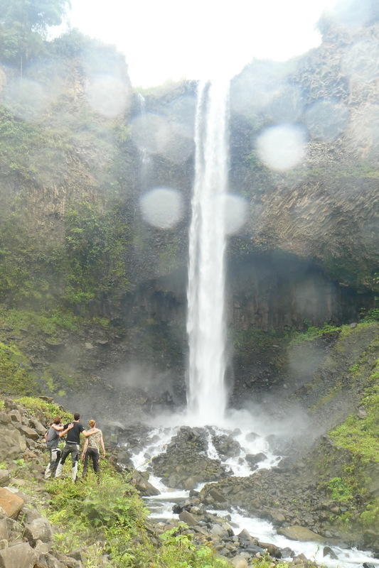 The triplets admiring a waterfall
